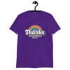 Purple t-shirt with an image of a rainbow and the words 'Thanks for the childhood trauma' printed on the front. The word Thanks is large and the rest of the words are smaller under.