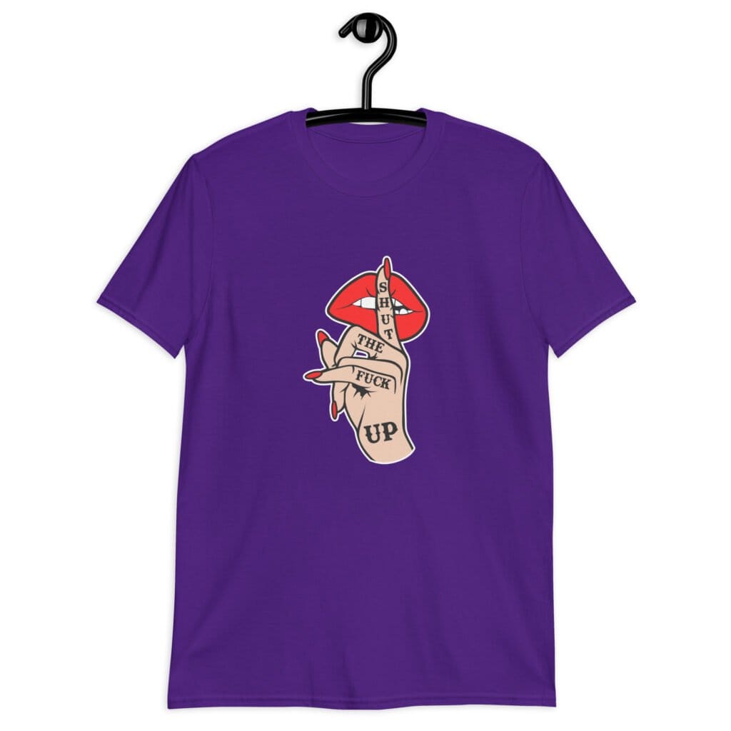 Purple t-shirt with an image of a hand over lips making the shh gesture. The words 'Shut the fuck up' are printed on the hand. The graphics are printed on the front.
