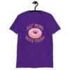 Purple t-shirt that has an image of a donut with pink icing and sprinkles and the text 'Eat more hole foods' printed on the front.