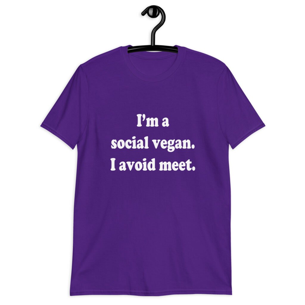 Purple t-shirt with the pun phrase 'I'm a social vegan. I avoid meet.' printed on the front.