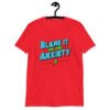 Red t-shirt with the phrase 'Blame is on the anxiety' printed on the front. The graphics are bold and in aqua and lime green.