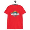 Red t-shirt with an image of a rainbow and the words 'Thanks for the childhood trauma' printed on the front. The word Thanks is large and the rest of the words are smaller under.