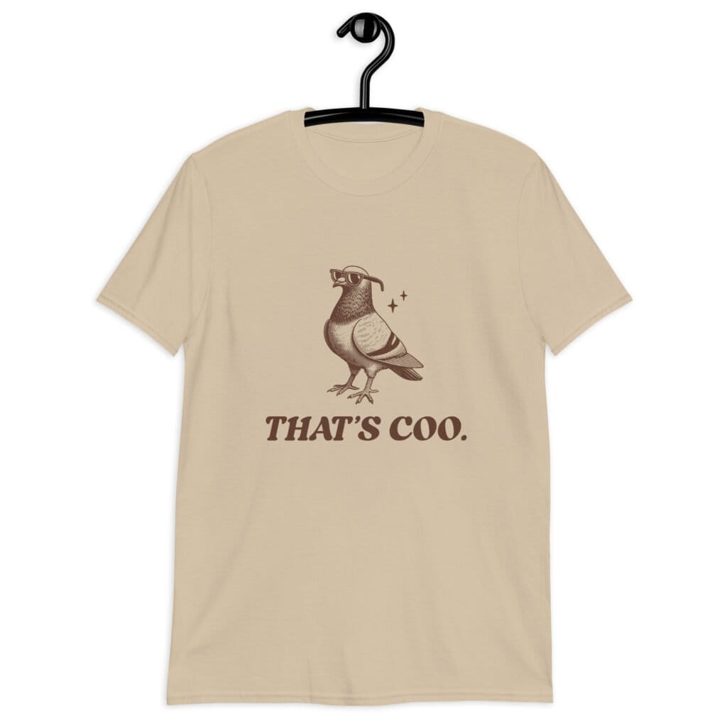 Sand color t-shirt with an image of a pigeon and the words 'That's coo.' printed on the front.