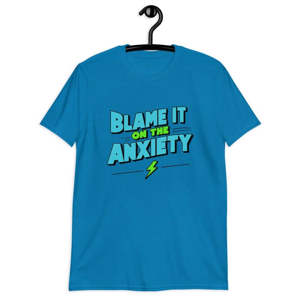 Sapphire blue t-shirt with the phrase 'Blame is on the anxiety' printed on the front. The graphics are bold and in aqua and lime green.