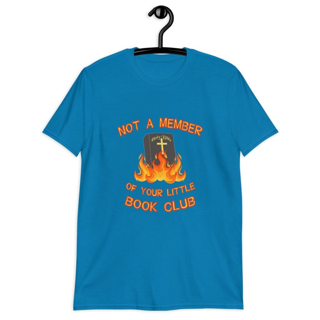 Sapphire blue t-shirt with image of a burning bible and the text 'Not a member of your little book club' printed on the front.