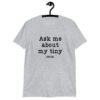 Sport grey t-shirt with the text 'Ask me about my tiny penis' printed on the front. The word tiny is much smaller than the rest of the text.