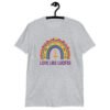 Sport grey t-shirt with an image of a boho style rainbow. There is an upside down cross in the center arch of the rainbow and the text 'Love like Lucifer' printed under. The graphics are printed on the front.