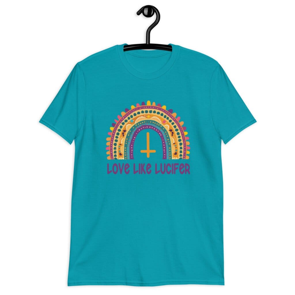 Tropical blue t-shirt with an image of a boho style rainbow. There is an upside down cross in the center arch of the rainbow and the text 'Love like Lucifer' printed under. The graphics are printed on the front.