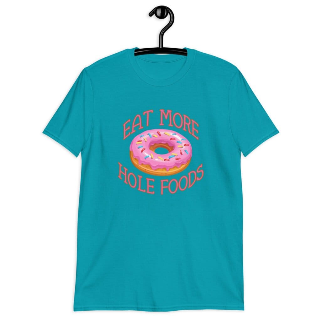 Tropical blue t-shirt that has an image of a donut with pink icing and sprinkles and the text 'Eat more hole foods' printed on the front.