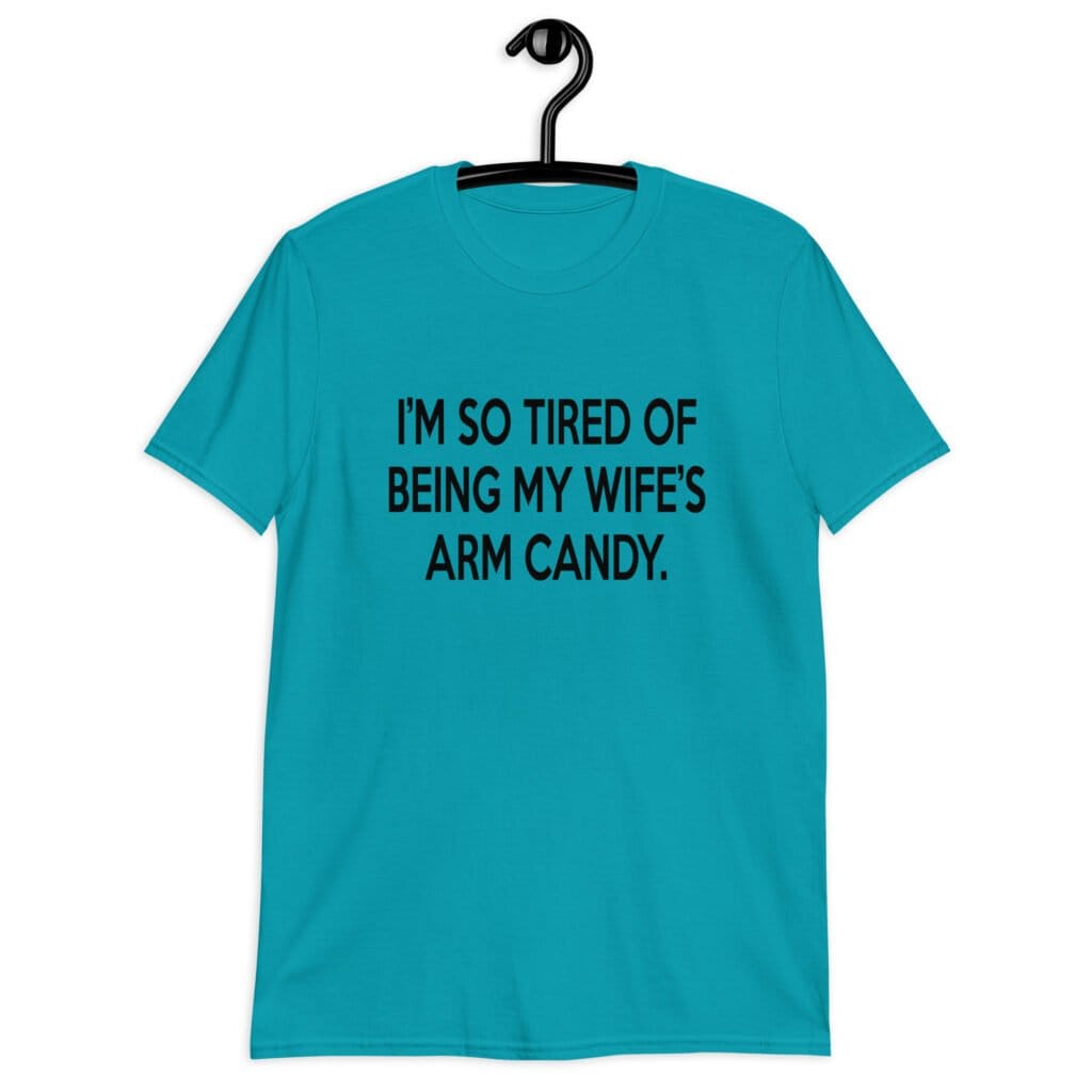 Tropical blue t-shirt with the funny phrase 'I'm so tired of being my wife's arm candy' printed on the front.