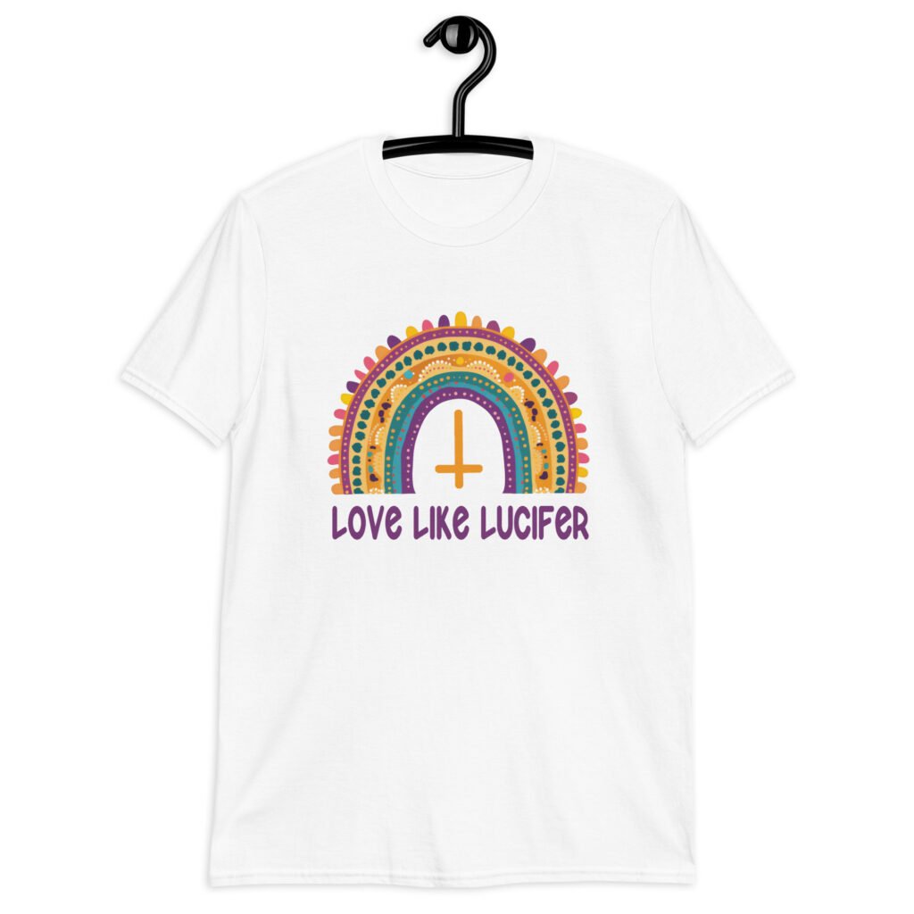 White t-shirt with an image of a boho style rainbow. There is an upside down cross in the center arch of the rainbow and the text 'Love like Lucifer' printed under. The graphics are printed on the front.