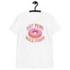 White t-shirt that has an image of a donut with pink icing and sprinkles and the text 'Eat more hole foods' printed on the front.