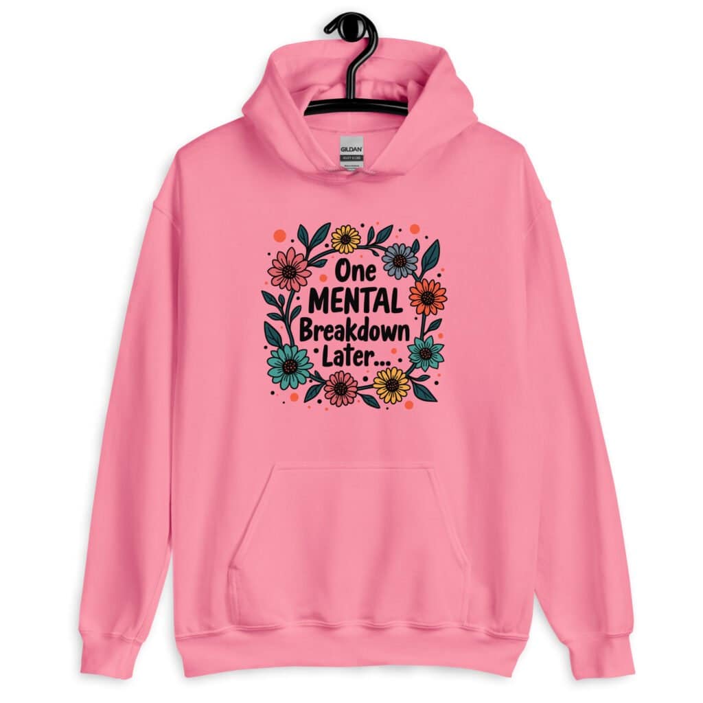 Azalea pink hoodie sweatshirt with a multi color floral wreath design printed on the front. The words 'One mental breakdown later...' are printed in the center of the wreath.