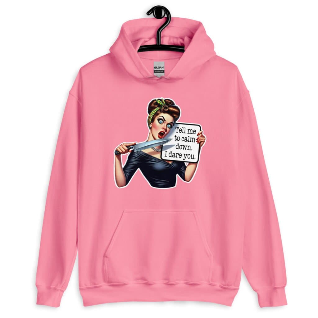 Azalea pink hoodie sweatshirt that has a graphic of an angry looking retro woman holding a knife and a sign. The sign says 'Tell me to calm down. I dare you.' The graphic is printed on the front of the hoodie.