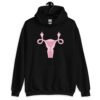 Black hoodie sweatshirt with image of a pink uterus flipping middle finger graphic printed on the front.