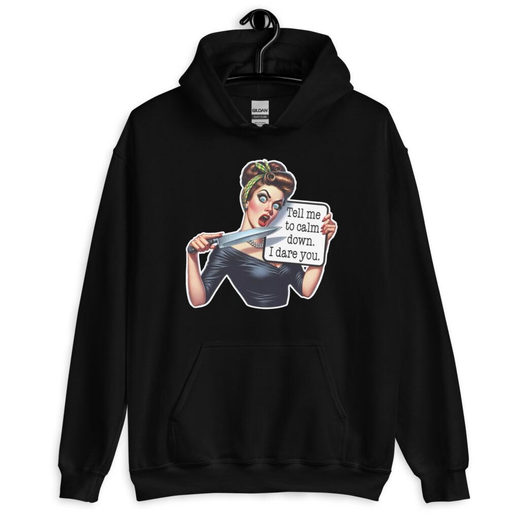 Black hoodie sweatshirt that has a graphic of an angry looking retro woman holding a knife and a sign. The sign says 'Tell me to calm down. I dare you.' The graphic is printed on the front of the hoodie.