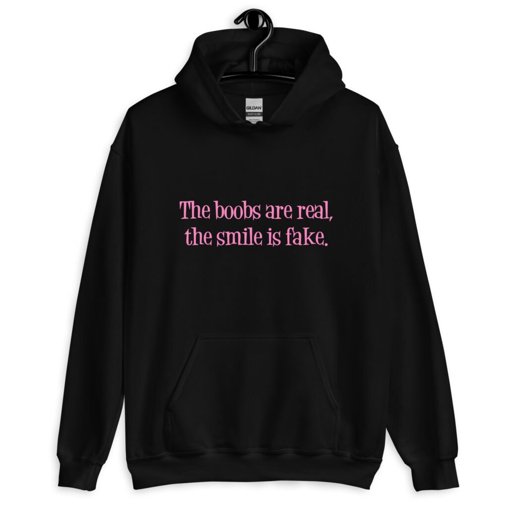 Black hoodie sweatshirt with the text 'The boobs are real, the smile is fake.' printed in pink on the front.