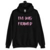 Black hoodie sweatshirt with the text 'Eve was framed' printed on the front in pink.