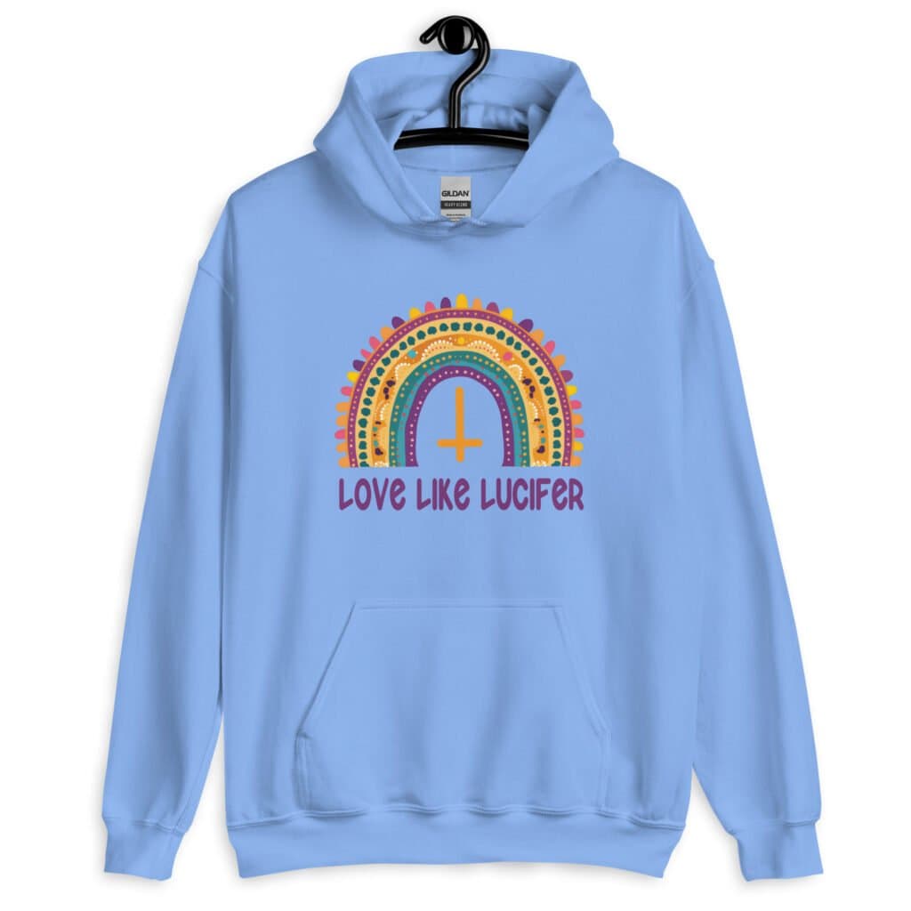 Carolina blue hoodie sweatshirt with an image of a boho style rainbow. There is an upside down cross in the center arch of the rainbow and the text 'Love like Lucifer' printed under. The graphics are printed on the front.