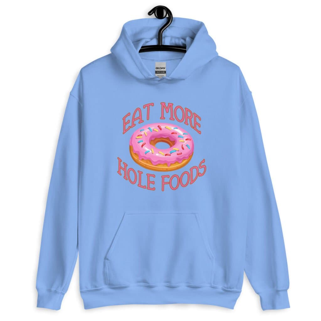 Carolina blue hoodie sweatshirt with an image of a donut with pink icing and sprinkles and the text 'Eat more hole foods' printed on the front.