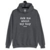 Dark heather grey hoodie sweatshirt with the text 'Ask me about my tiny penis' printed on the front. The word tiny is much smaller than the rest of the text.