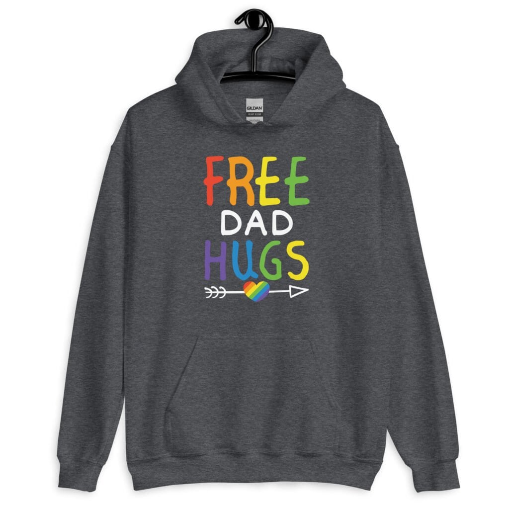 Dark heather grey hoodie sweatshirt with the text 'Free Dad hugs' printed on the front in rainbow letters.
