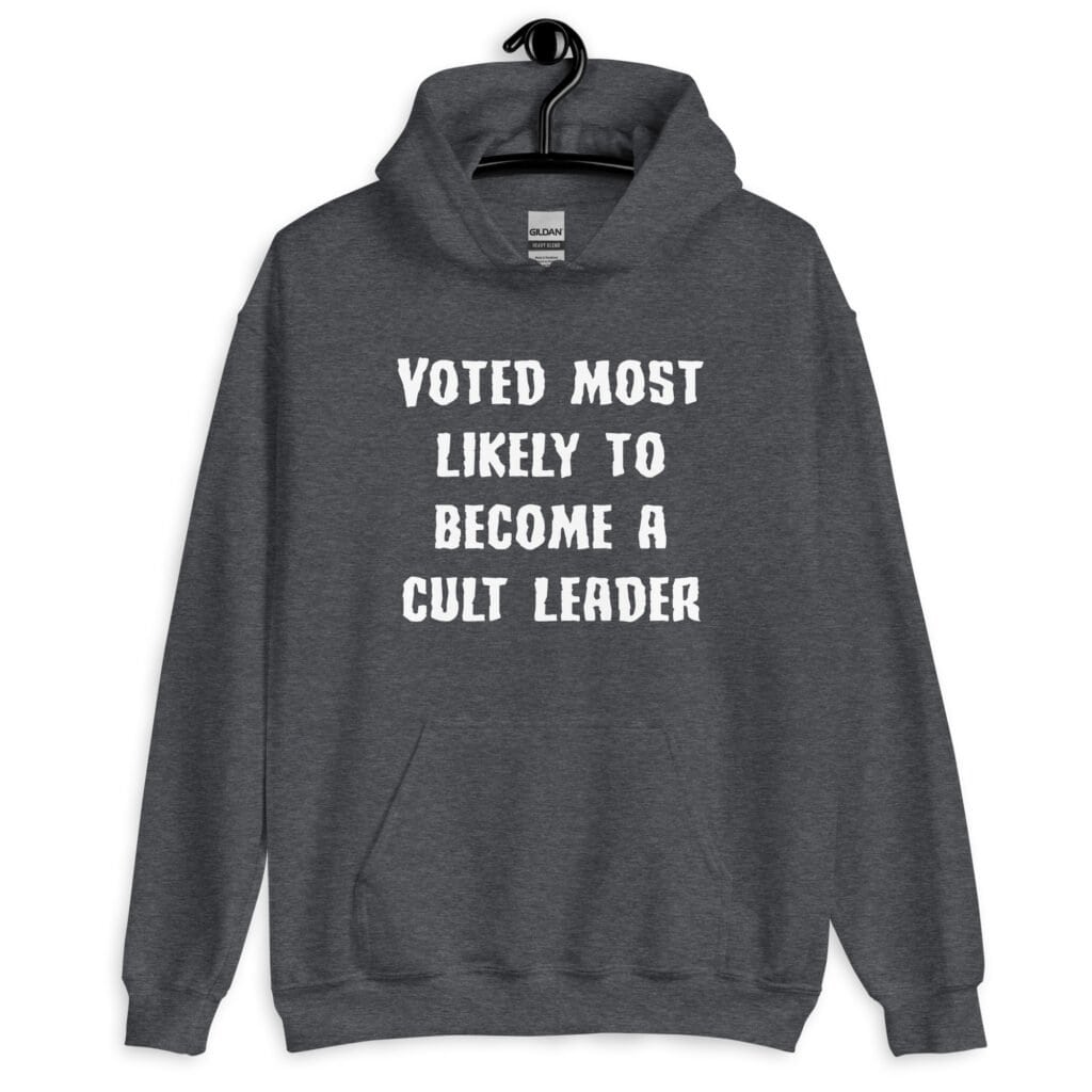 Dark heather grey hoodie sweatshirt with the text 'Voted most likely to become a cult leader' printed on the front.