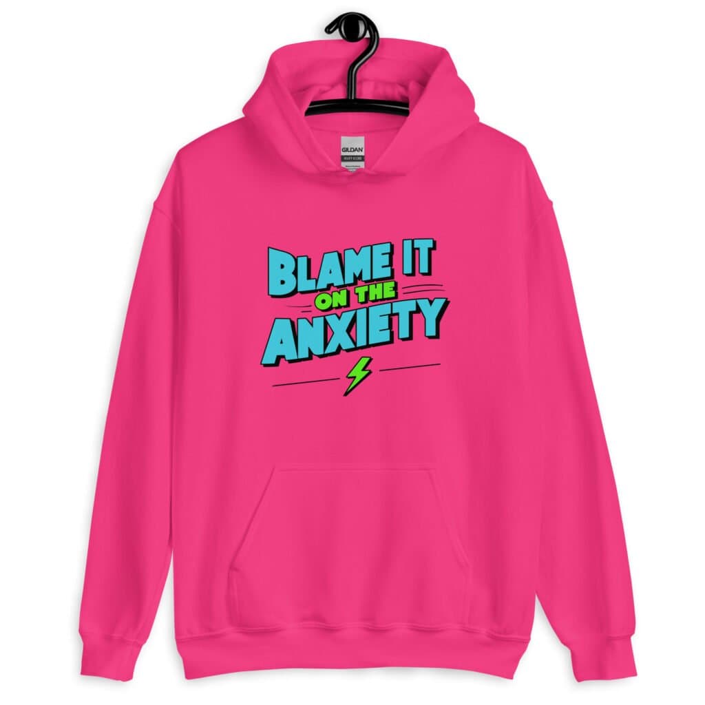 Heliconia pink hoodie sweatshirt with the phrase 'Blame is on the anxiety' printed on the front. The graphics are bold and in aqua and lime green.