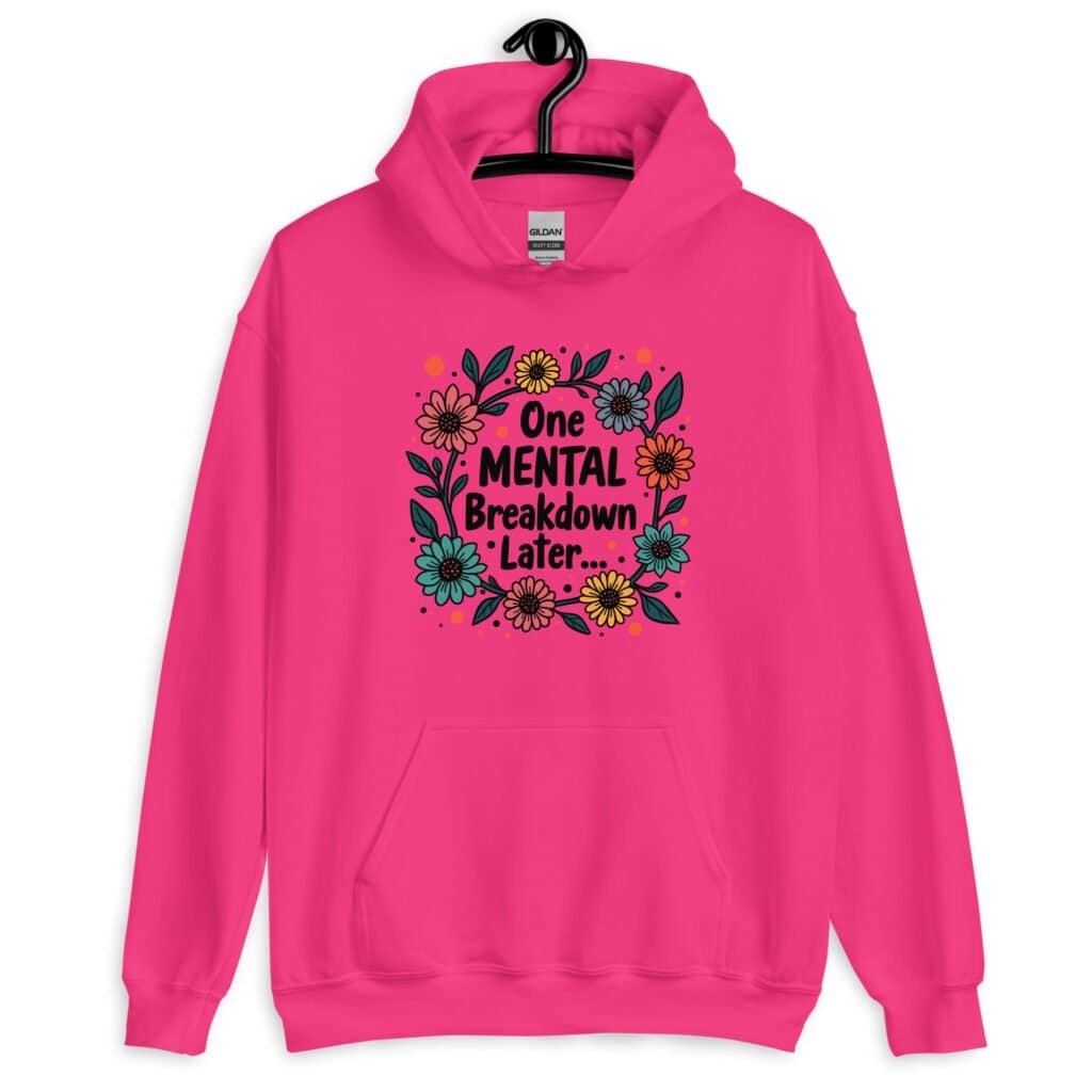 Heliconia pink hoodie sweatshirt with a multi color floral wreath design printed on the front. The words 'One mental breakdown later...' are printed in the center of the wreath.