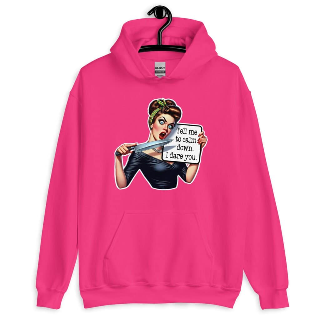 Heliconia pink hoodie sweatshirt that has a graphic of an angry looking retro woman holding a knife and a sign. The sign says 'Tell me to calm down. I dare you.' The graphic is printed on the front of the hoodie.