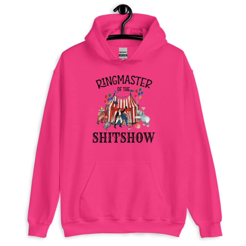 Heliconia pink hoodie sweatshirt with a circus theme graphic and the text 'Ringmaster of the Shitshow' printed on the front.