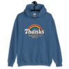 Indigo blue hoodie sweatshirt with an image of a rainbow and the words 'Thanks for the childhood trauma' printed on the front. The word Thanks is large and the rest of the words are smaller under.