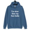 Indigo blue hoodie sweatshirt with the text 'I'm nicer than my face looks' printed on the front.