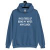 Indigo blue hoodie sweatshirt with the funny phrase 'I'm so tired of being my wife's arm candy' printed on the front.