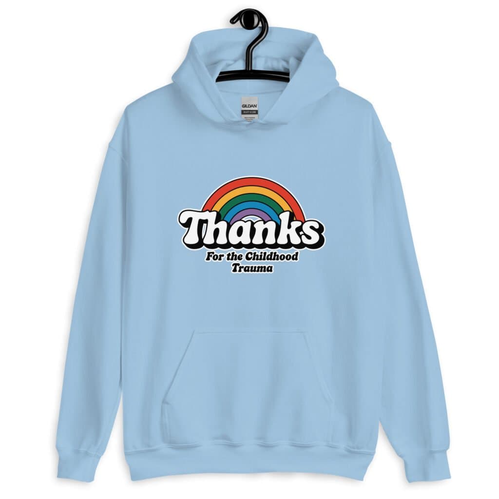 Light blue hoodie sweatshirt with an image of a rainbow and the words 'Thanks for the childhood trauma' printed on the front. The word Thanks is large and the rest of the words are smaller under.