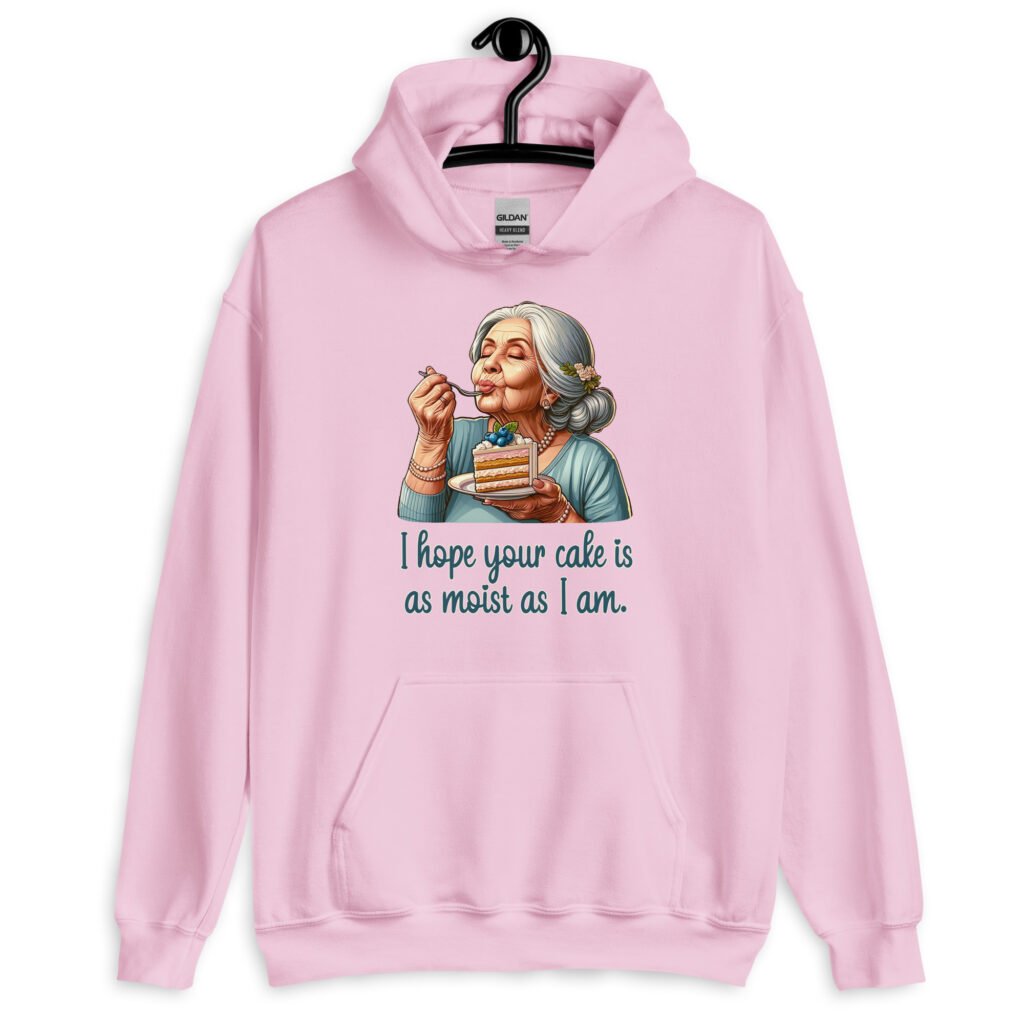 Light pink hoodie sweatshirt with an image of grey haired older woman enjoying a bite of a piece of cake with the words 'I hope your cake is as moist as I am' printed on the front.