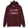 Maroon hoodie sweatshirt with the text 'Eve was framed' printed on the front in pink.