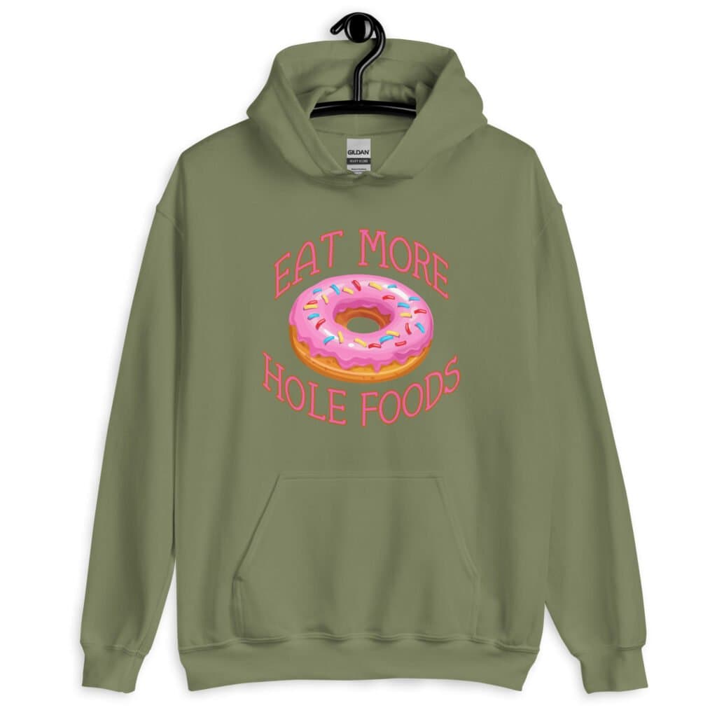 Military green hoodie sweatshirt with an image of a donut with pink icing and sprinkles and the text 'Eat more hole foods' printed on the front.