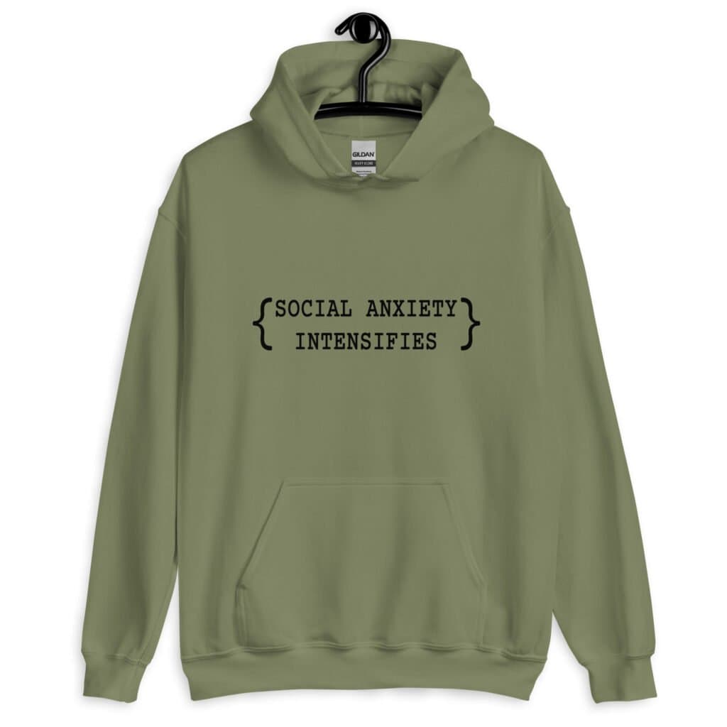 Military green hoodie sweatshirt with the text 'Social anxiety intensifies' printed on the front.