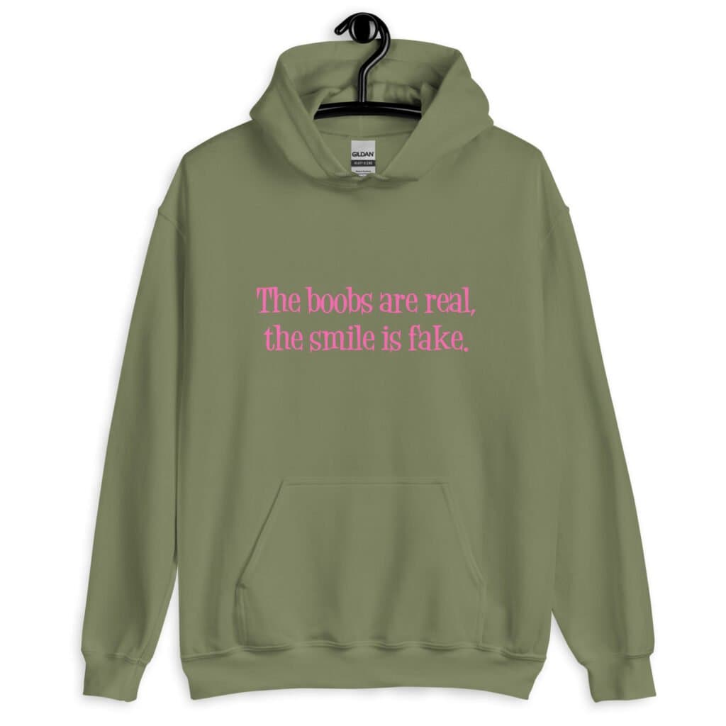 Military green hoodie sweatshirt with the text 'The boobs are real, the smile is fake.' printed in pink on the front.