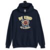 Navy blue hoodie sweatshirt with an image of a flower and the words Be kind above the flower in yellow bold block font. The words Of a bitch are smaller in script font under the flower. The design is printed on the front.