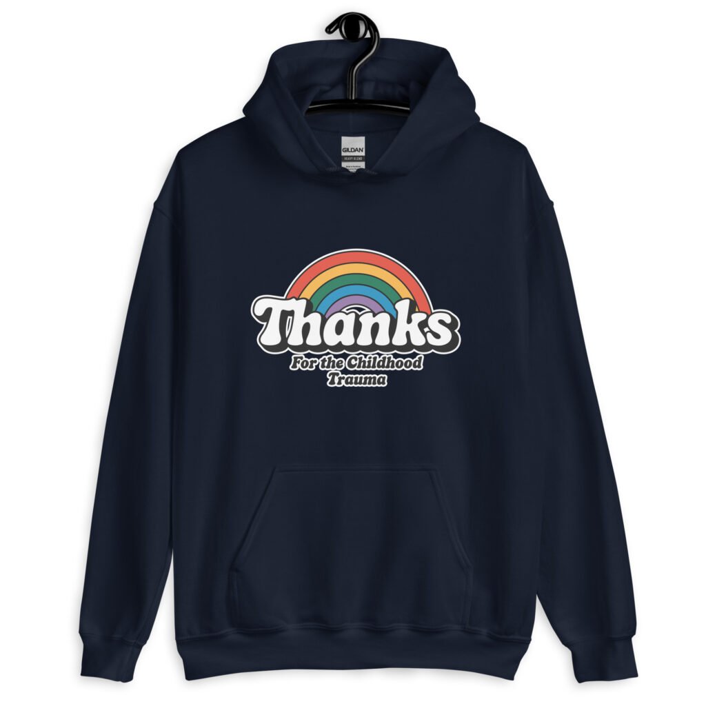 Navy blue hoodie sweatshirt with an image of a rainbow and the words 'Thanks for the childhood trauma' printed on the front. The word Thanks is large and the rest of the words are smaller under.