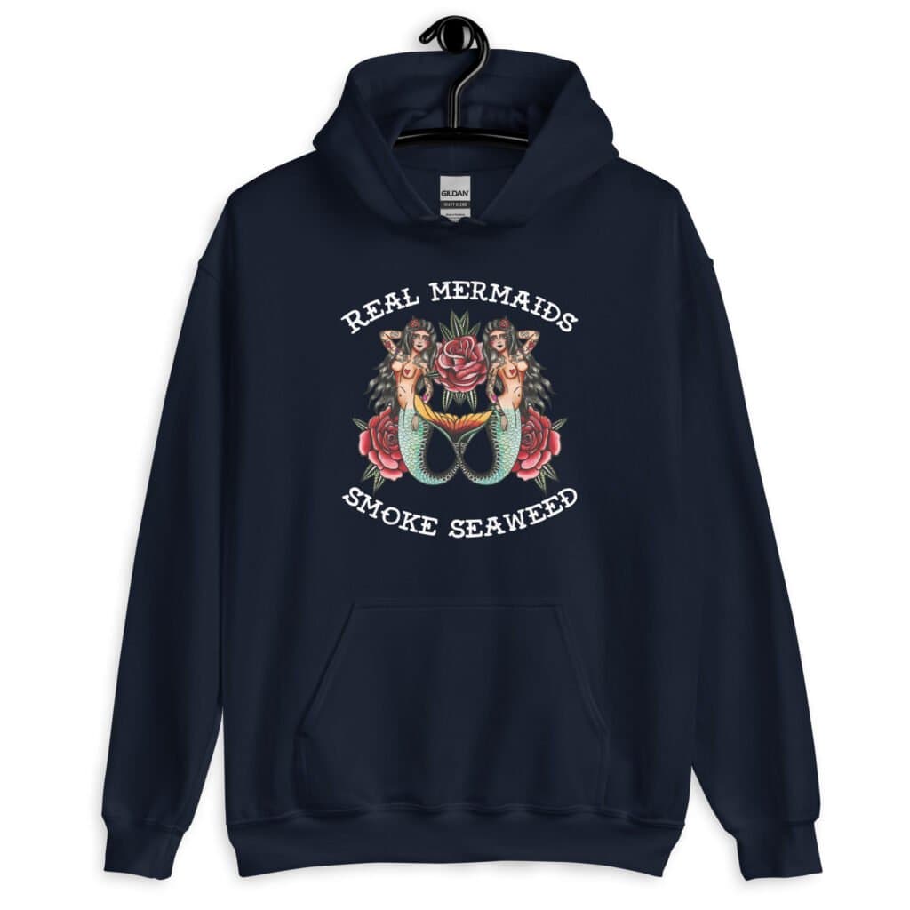Navy blue hoodie sweatshirt with image of 2 mermaids and the text 'Real mermaids smoke seaweed' printed on the front.