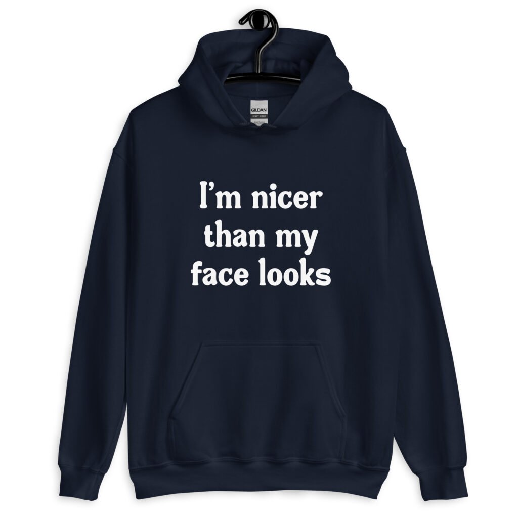 Navy blue hoodie sweatshirt with the text 'I'm nicer than my face looks' printed on the front.