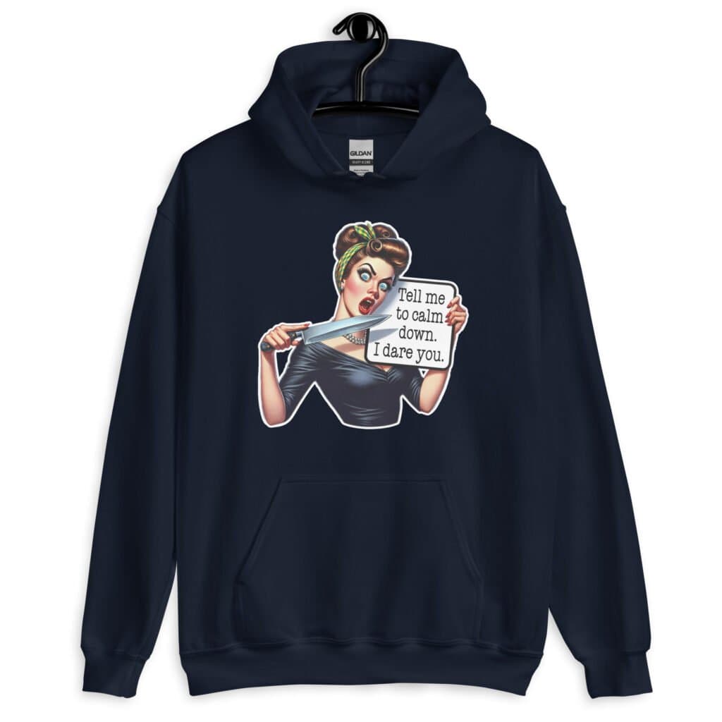 Navy blue hoodie sweatshirt that has a graphic of an angry looking retro woman holding a knife and a sign. The sign says 'Tell me to calm down. I dare you.' The graphic is printed on the front of the hoodie.