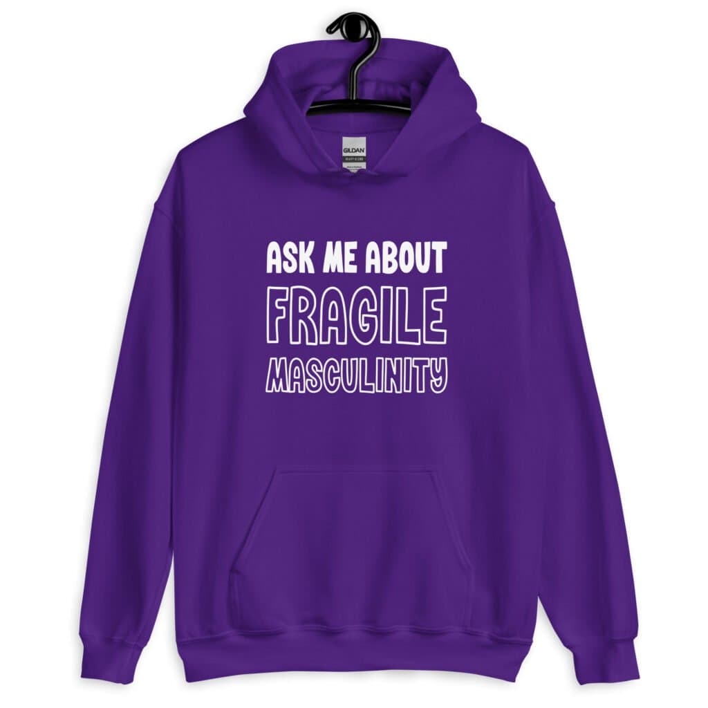 Purple hoodie sweatshirt with the text 'Ask me about fragile masculinity' printed on the front.