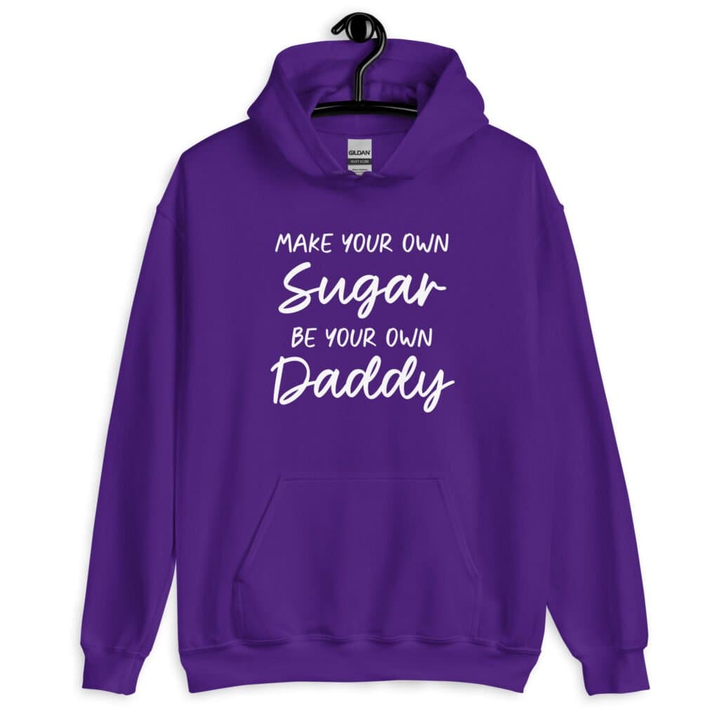 Purple hoodie sweatshirt with the text 'Make your own sugar Be your own Daddy' printed on the front.