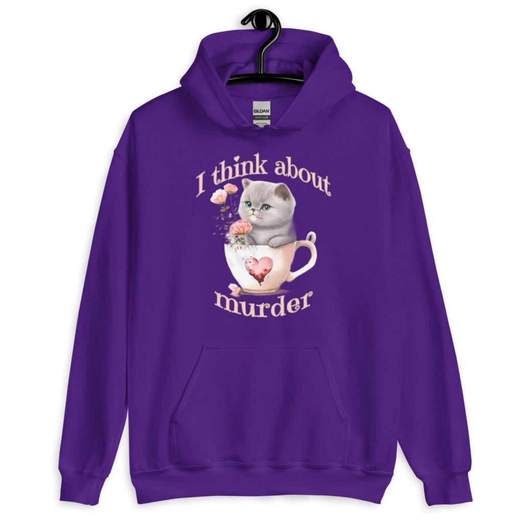 Purple hoodie sweatshirt that says 'I think about murder' with image of cute fluffy kitten sitting in a teacup printed on the front.