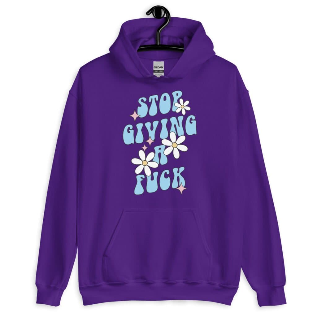 Purple hoodie sweatshirt with a retro daisy and star design and the text 'Stop giving a fuck' printed on the front.