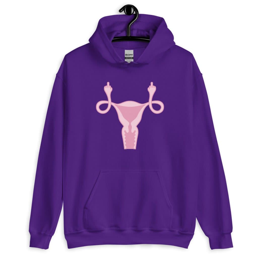 Purple hoodie sweatshirt with image of a pink uterus flipping middle finger graphic printed on the front.